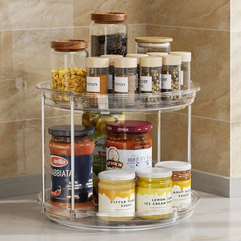 2 Tier Lazy Susan Turntable Organizer For Narrow Cabinets with jars and spices, clear plastic, placed in a kitchen corner.