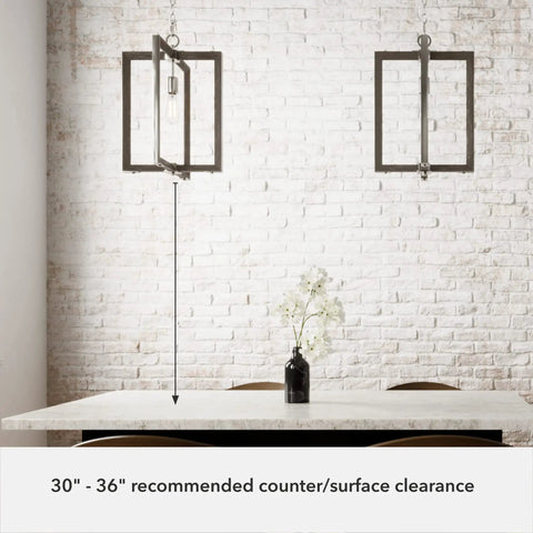 Woodburn One Light Pendant Light In Brushed Nickel Dimmable Modern Rectangle Fixture hanging over kitchen table