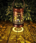 Outdoor Solar Lanterns Waterproof Weatherproof Metal Hummingbird Garden Decor casting floral patterns in garden