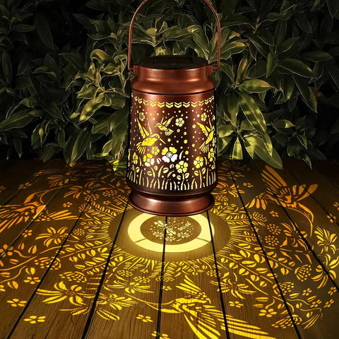 Outdoor Solar Lanterns Waterproof Weatherproof Metal Hummingbird Garden Decor casting floral patterns in garden