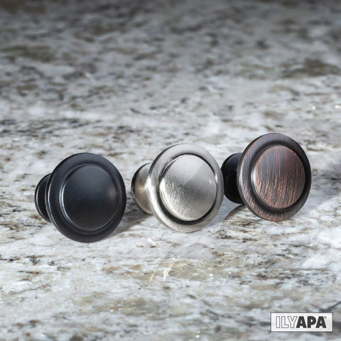 Oil Rubbed Bronze Cabinet Knobs One And One Quarter Inch Round Drawer Handles Pack Of Forty Everyday Durable Kitchen Cabinet Hardware For Cabinets, Dressers And Home Projects Includes Free One Inch And One And Three Quarter Inch Lengths on a granite surface, displaying three different finishes.