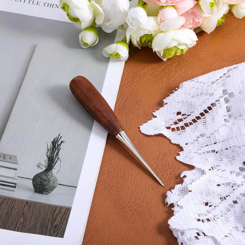 Heavy Duty Leather Working Awl on leather surface with walnut handle, 4.6 inch tool for precise bookbinding and woodworking craft projects.