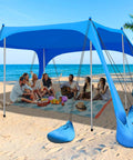 Big Family Beach Tent Sun Shelter 11x10 Ft With 12 Sandbags UPF 50 Plus Shade Canopy set up on a sandy beach with people underneath.