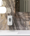 No Sweat Wall Mounted Manual Soap And Hand Sanitizer Dispenser 1000 Ml White installed on a marble wall with a modern sink.
