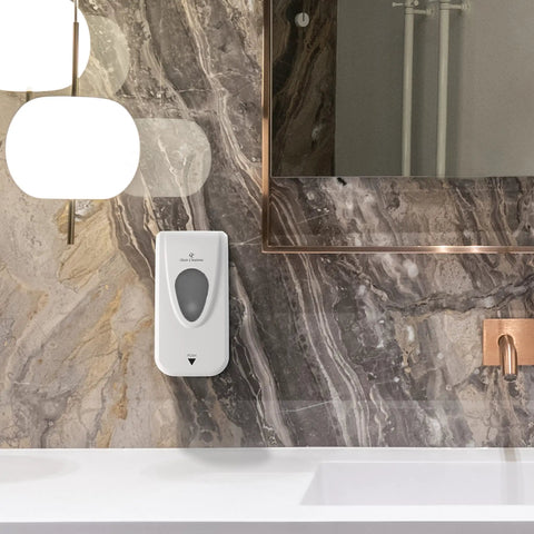 No Sweat Wall Mounted Manual Soap And Hand Sanitizer Dispenser 1000 Ml White installed on a marble wall with a modern sink.