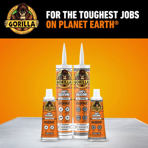 Front view of four Gorilla 100% silicone sealant cartridges and bottles; orange labels, white nozzles; clear sealant.
