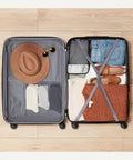 Amazon Basics 30-inch hardside luggage, open view showing clothing; black shell, grey interior