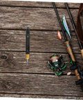 KICHOUSE stainless steel detacher tool with black body and yellow base, hanging beside fishing rods on a wooden dock
