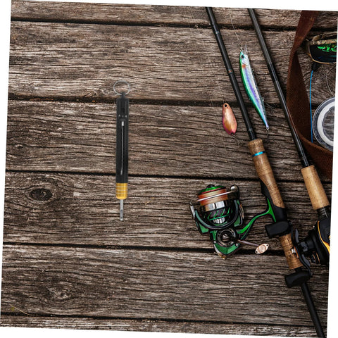KICHOUSE stainless steel detacher tool with black body and yellow base, hanging beside fishing rods on a wooden dock