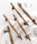 Get The Look You Want With These Super Stylish Vintage Antique Brass Cabinet Pulls That Have 5 Inch Hole Centers displayed with screws
