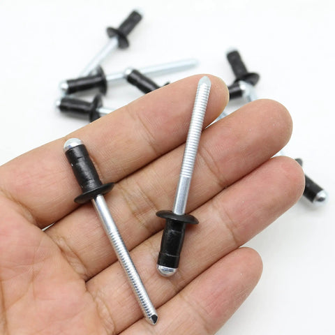 Two Straight Up Solid Aluminum Fuel Door Rivets For Toyota Gas Cap Hatch Snap Fasteners held in hand, showcasing black stems.