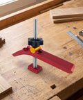 Hilitand T Track Hold Down Clamp Is The Real Deal For Adjustable Metal Clamps on a workbench gripping wooden boards.