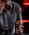Man holding ProTac 1L-1AA 350-Lumen Compact Tactical LED Flashlight With Alkaline Battery Coyote Finish for inspection.
