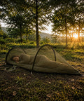 Two In One Pop Up Hammock Tent With Mosquito Net For One Person in a forest at sunrise, instant outdoor setup with breathable mesh.