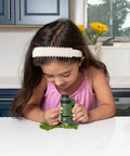 LED Lighted Pocket Microscope With 20x To 40x Zoom For Clear Close Ups Ultra Portable 2 Ounce Handheld Scope Includes Two Slides And Base Stand Compact 3.9 By 2.1 By 1.1 Inch Body Great For Students Hobbyists Science Buffs And On The Go Field Work, child using green handheld microscope