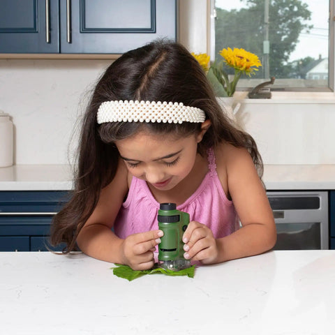LED Lighted Pocket Microscope With 20x To 40x Zoom For Clear Close Ups Ultra Portable 2 Ounce Handheld Scope Includes Two Slides And Base Stand Compact 3.9 By 2.1 By 1.1 Inch Body Great For Students Hobbyists Science Buffs And On The Go Field Work, child using green handheld microscope
