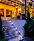 Solar Powered Outdoor Fence Lights 24 Pack Waterproof Stainless Steel Deck And Stair Lamps illuminating outdoor stairs at night