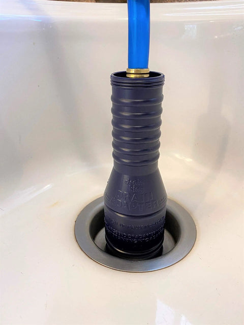 VIP2 Drain Unclogging Kit For 1.5 To 3 Inch Kitchen Drains in action with water powered cleaner inserted in sink drain