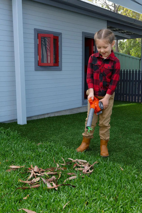 Child using Real Feel Toy Leaf Blower That Lights Up And Actually Blows Air Kid Friendly Mini Tool For Ages 3 And Up in backyard