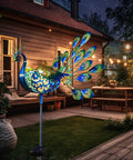 Peacock Solar Garden Stake Lights For Pathways And Backyard Decor Metal Outdoor Lights illuminating patio at night