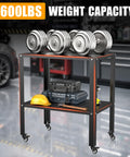 Pro-Grade Welding Workbench Table With Heavy-Duty Steel Construction featuring weights, tools, and helmet on shelves in a garage