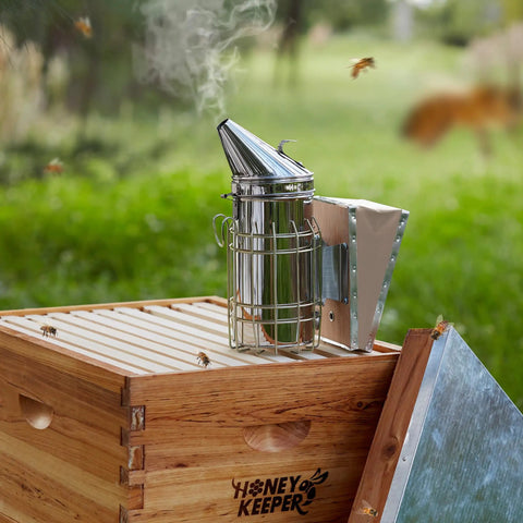 Pro Grade Beehive Smoker With Stainless Steel Body And Heat Shield for hive inspections on wooden bee box outdoors
