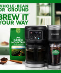 Green Mountain Coffee bag next to a Keurig coffee maker and glass of iced coffee on a kitchen counter.