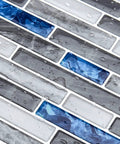 Close-up of wet Peel and Stick Marble Backsplash Tile Set for Kitchen and Bathroom 12x12 Inch Vinyl Decorative Tiles with blue accents.