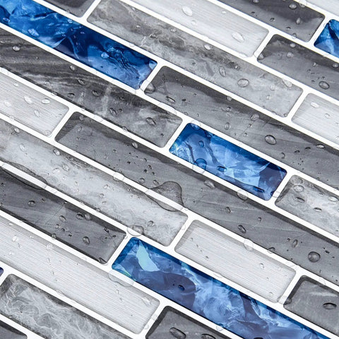 Close-up of wet Peel and Stick Marble Backsplash Tile Set for Kitchen and Bathroom 12x12 Inch Vinyl Decorative Tiles with blue accents.