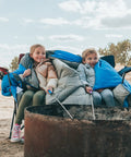 Kids sitting in All Season Sleeping Bag For Adults And Kids, Lightweight And Cozy Waterproof Gear For Backpacking Camping And Hiking, Temperature Rated 50F To 77F
