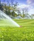 Heavy Duty Rock Solid Half Inch Zinc Impact Sprinkler 2 Pack watering lawn with adjustable spray in grassy field.