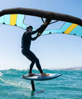 Person using Awesome Inflatable Wingsurfer Kite For Windsurfing And Water Play Portable Handheld Foil Window Design over ocean