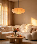 20 Inch Oval Paper Lantern Pendant Light White Rice Paper Ceiling Lamp Japanese Style in warm living room with white couch.
