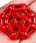 Red Cast Iron Shutoff Valve Handles Pack Of 10 With Flat Bottom Design held in hand, showing metal wheel detail