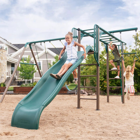 Kids playing on Outdoor Monkey Bar Adventure Swing Set with Three Belt Swings, Trapeze Bar, and Nine Foot Wavy Slide in backyard