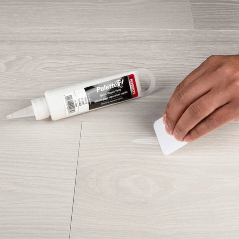 Applying Quick Fix Putty For Wood Laminate And Vinyl Floors Acrylic Based Gap Filler In White on vinyl floor