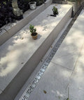 Heavy Duty Trench Drainage System Kit With Stainless Steel Grate For Outdoor Pathways Lawn And Courtyard French Drain Style Drainage That Redirects Rainwater From Driveways To Hidden Subsurface Channels installed along garden steps.