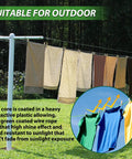 All In One Outdoor 100 Ft PVC Coated Steel Cable Kit with clothesline in garden setting, suitable for hanging laundry outdoors.