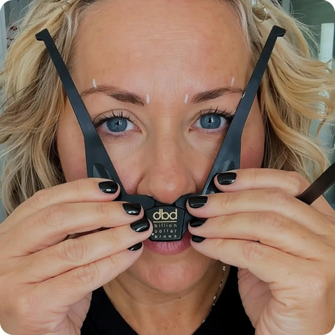 Person using Brow Buddy Kit With Patented Symmetrical Shaping Tool And Contouring Stencil Pro Brow Mapping Set With White Pencil.