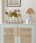 Modern Mid Century Brass And Wood Cabinet Pulls 3 Inch Center To Center Four Pack installed on rattan-style cabinet doors