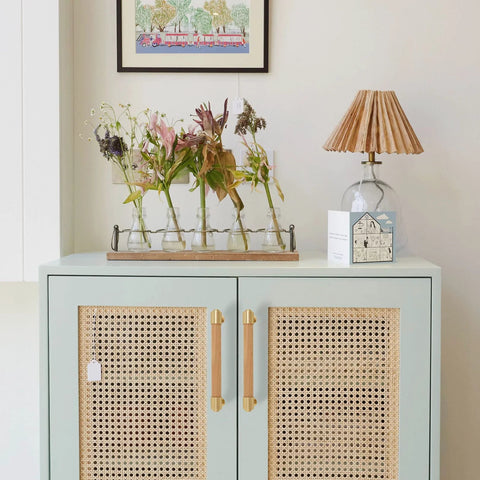 Modern Mid Century Brass And Wood Cabinet Pulls 3 Inch Center To Center Four Pack installed on rattan-style cabinet doors