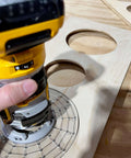 Hand using XL universal base plate converts your router for Porter Cable style bushings and doubles as a precision circle cutting guide.