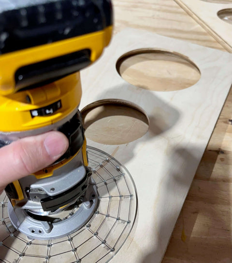 Hand using XL universal base plate converts your router for Porter Cable style bushings and doubles as a precision circle cutting guide.