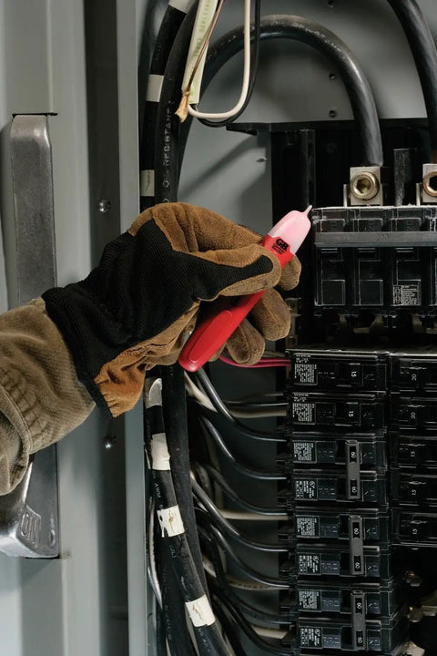 Person using Household Electrical Tester Kit For Do It Yourself Homeowners With Voltage Tester on a circuit box.