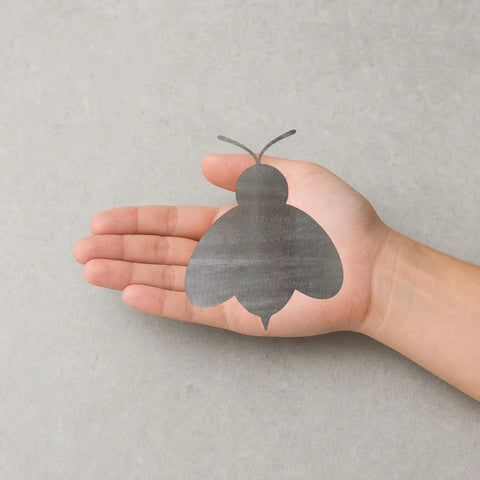 Hand holding Raw Steel Bee Cutout Wall Art 12 Inch Dope For DIY Projects And Garden Decor Ready For Paint Patina Clear Coat And Welding