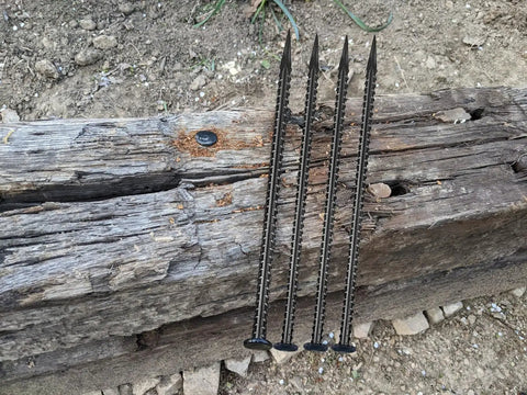 Beefy 16 Inch Rebar Ground Stakes Half Inch Diameter Galvanized Steel Anchors for landscaping shown on wood and soil