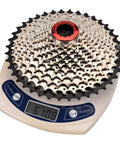 11 Speed Bike Cassette 11-40T Wide Range Sprocket For Shimano SRAM Sunrace HG Systems, Fits Mountain And Road Bikes, Rugged Steel Build For Smooth Shifts And Killer Value., 11-speed steel cassette on scale