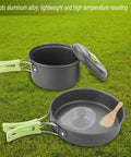 8 Piece Portable Camping Cookware Set for Outdoor On-The-Go Cooking Lightweight Aluminum pots pans with green handles on grass