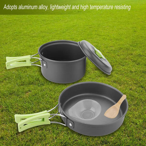 8 Piece Portable Camping Cookware Set for Outdoor On-The-Go Cooking Lightweight Aluminum pots pans with green handles on grass