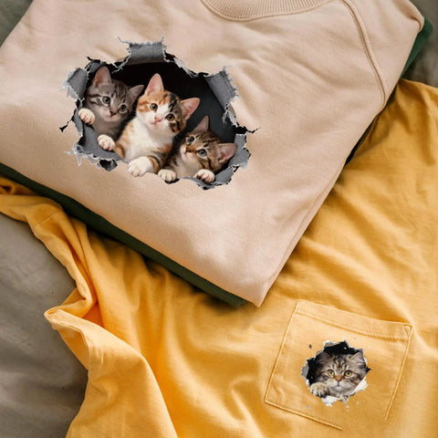 Eight Piece Cat Break Through Wall Iron On Transfers Kit With Eight Kitten Designs For T Shirts Hoodies Jackets Washable DTF Ready To Press Lit DIY Gift For Clothing displayed on beige and yellow shirts.